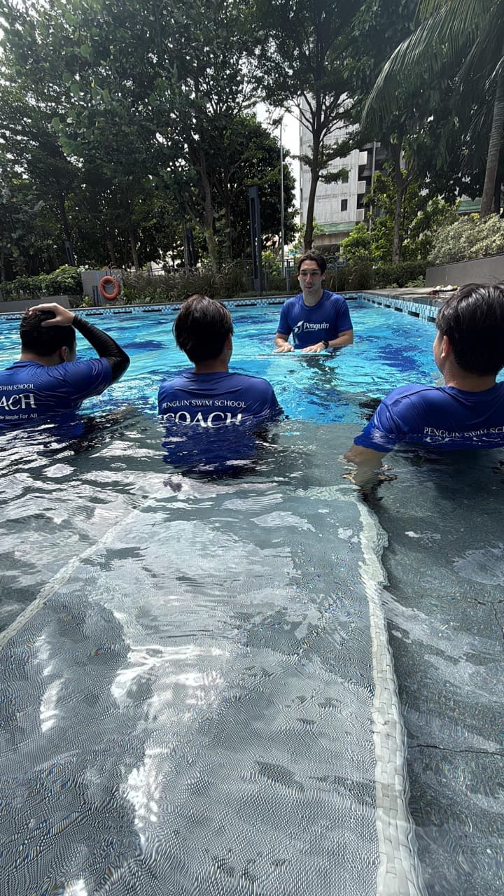 Penguin Academy swim teachers developing their practical coaching skills in a Singapore pool