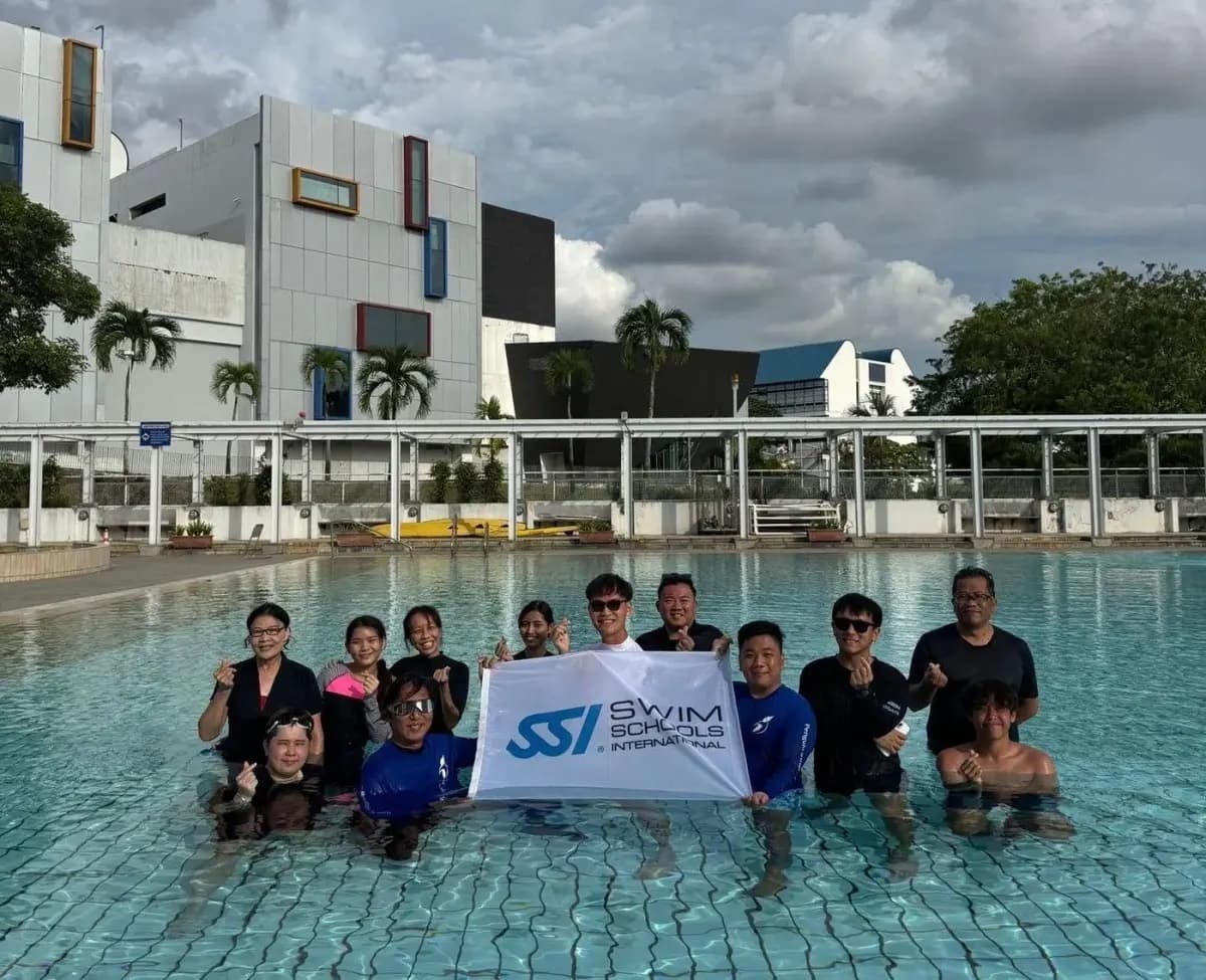 Penguin Academy swim teacher community in Singapore with an SSI flag